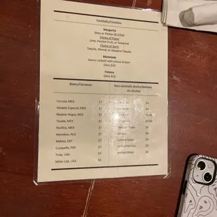 a menu and a phone on a table