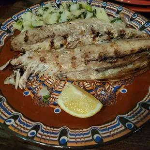 a plate of fish and vegetables