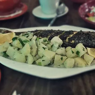 a plate of fish and potatoes