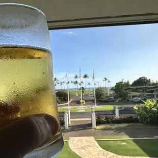 a person holding a glass of beer