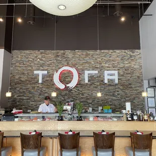 Facing the sushi bar inside