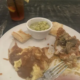 Fried chicken with crawfish sauce, mashed potatoes, Butter beans, French bread and