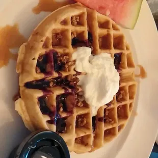 The Tyler: Belgium waffle topped with caramel cream, vanilla bean whipped cream, cashed pecans, and berry coulis