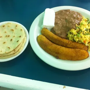 Tradicional Desayunos de El Salvador: Scrambled eggs, fried plantains, refried beans, and homemade cheese with tortillas!