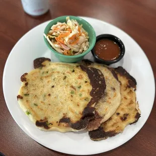 a plate of flatbreads and a bowl of coleslaw