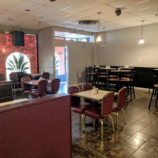 Large seating area with booths, tables, high tops, and bar