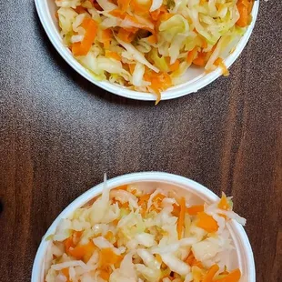 two plates of coleslaw