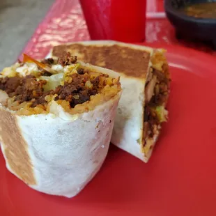 a burrito on a red plate