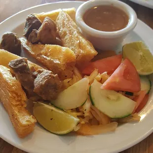 Yucca frita with fried pork and cabbage salad