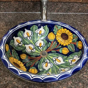 a sink decorated with sunflowers