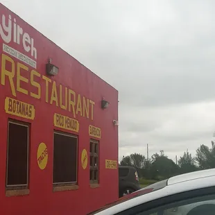 a car parked in front of a restaurant