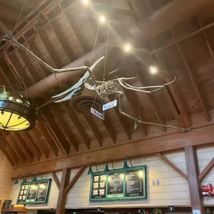 a restaurant with a wooden ceiling