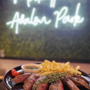 a plate of steak and french fries