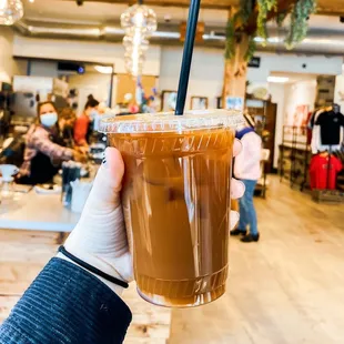 a hand holding a cup of coffee