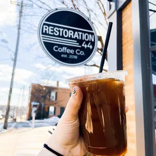 a hand holding a cup of coffee