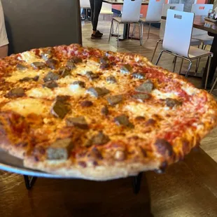 One large meatball and ricotta pizza.