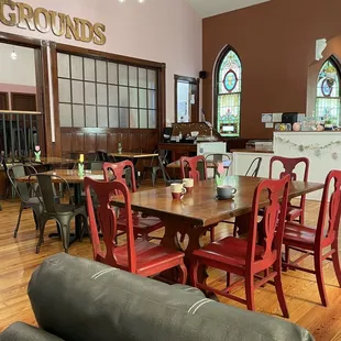 a dining room with red chairs