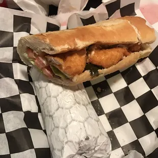 The breaded cutlet with lettuce, tomatoes, and pickles