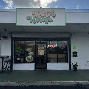 Outside with outdoor seating and cute handmade window paintings