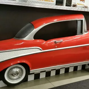 a red and white car on display