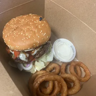 Huge 1/2 pound burger with onion rings.