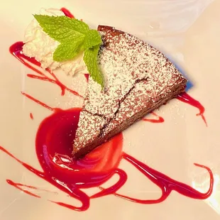 Decadent flourless chocolate cake with raspberry sauce