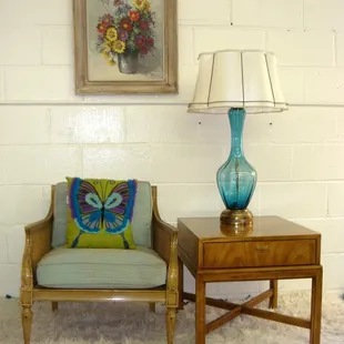 A great selection of vintage textiles including needlepoint pillows and vintage curtain panels