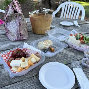 Pictured is an $18 hummus plate and a $23 charcuterie board from an outside "caterer"