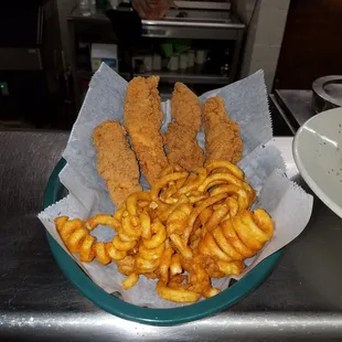 a basket of fried fish and fries