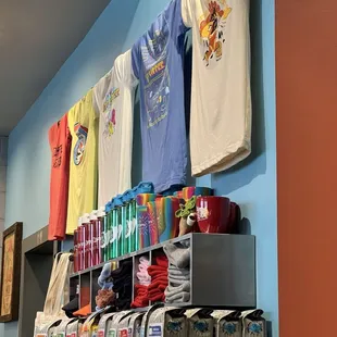 t - shirts hanging on a rack in a store