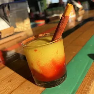 Mangonada- House mango frozen marg with chamoy, tajin, and a tamarind candy straw