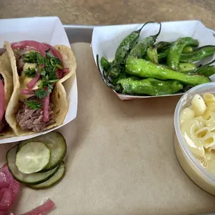 Brisket tacos, Shishito peppers, Mac n cheese, with house made pickles and onions.