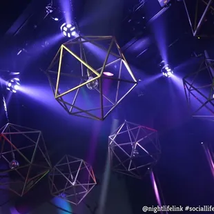 a group of geometric lights hanging from the ceiling