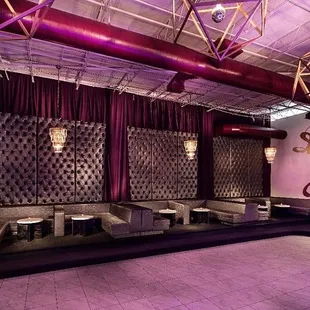 the interior of a nightclub with purple lighting