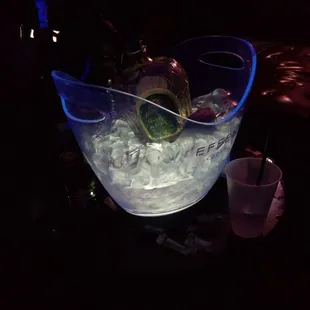 a large ice bucket filled with ice and garnish