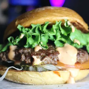 a hamburger with lettuce and cheese