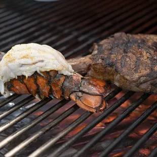 a steak and lobster on a grill
