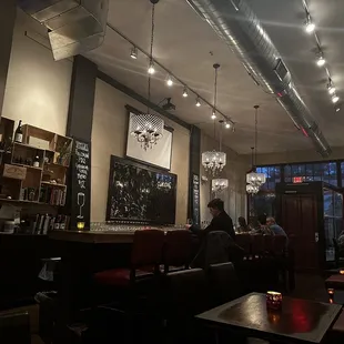 people sitting at tables in a restaurant