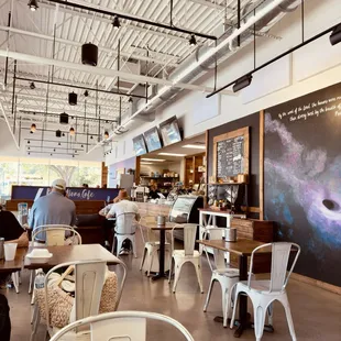 the interior of a restaurant with tables and chairs