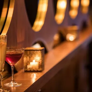 a glass of wine on a bar