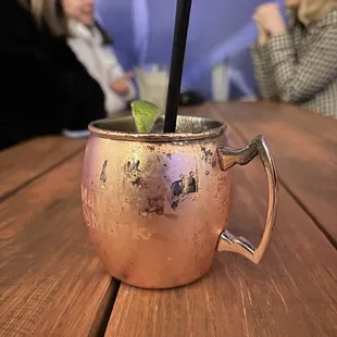a copper mug with a straw and a garnish garnish