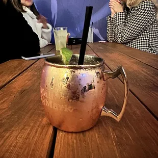 a copper mug with a drink in it
