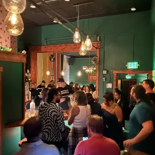 a large group of people sitting at a bar