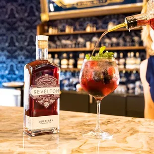 a woman pouring a drink