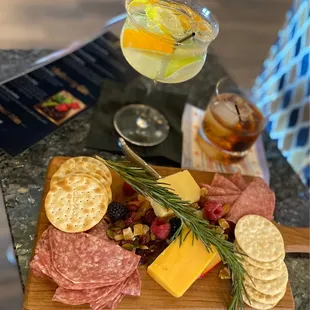a platter of meat, cheese and crackers