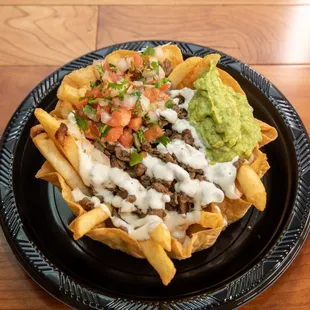 a plate of nachos and guacamole