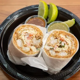 two burritos on a black plate