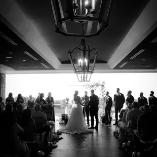 Indoor wedding venue aisle with the venue's gorgeous wood lights and a wide aisle