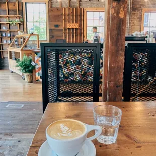 a cup of coffee on a wooden table