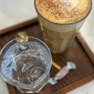 a glass of iced coffee and ice cubes